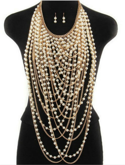 Women’s gold chain and pearl body jewelry