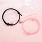 Couple’s matching pink and black connecting heart bracelet set