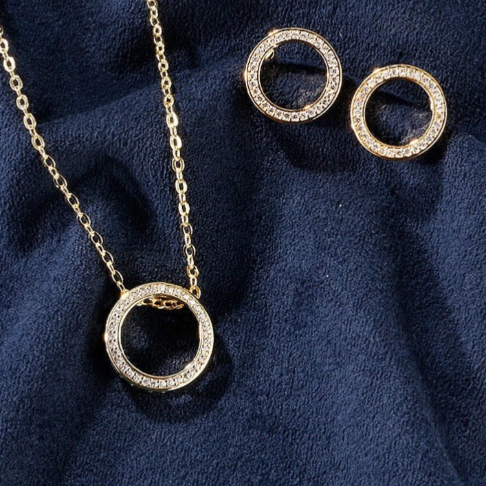 Women’s gold and diamonds circle necklace and earrings set